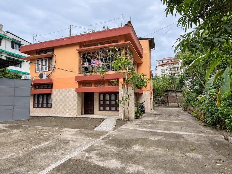 Exterior of the building that houses Aurum Stays, with a paved courtyard